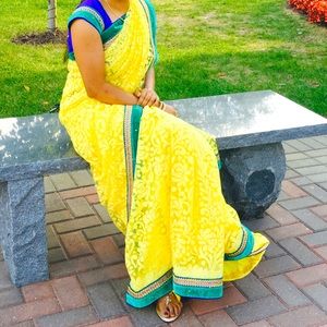 Yellow party saree with blue blouse